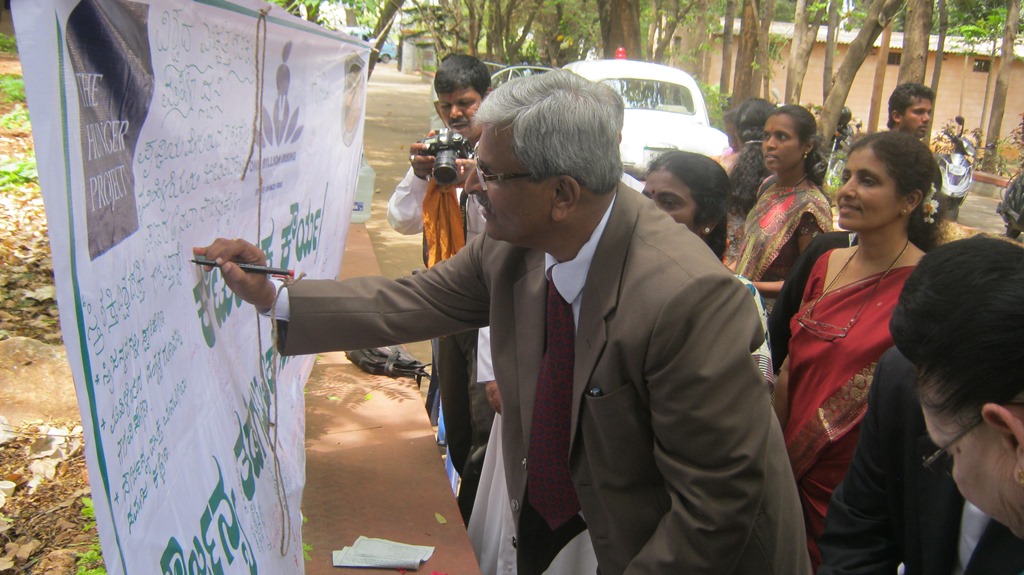 Mr. Mohan Sripadha Sankoli, Principal District Judge of Mysore, imprinting his signature Violence against women Mr. Mohan Sripadha Sankoli, Principal District Judge of Mysore, imprinting his signature Violence against women