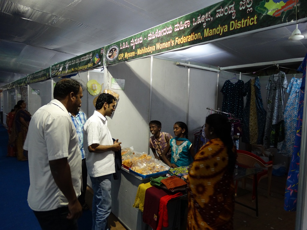 SHG members participating Mysore dasara Exhibition and Director interacting with their family member SHG members participating Mysore dasara Exhibition and Director interacting with their family member